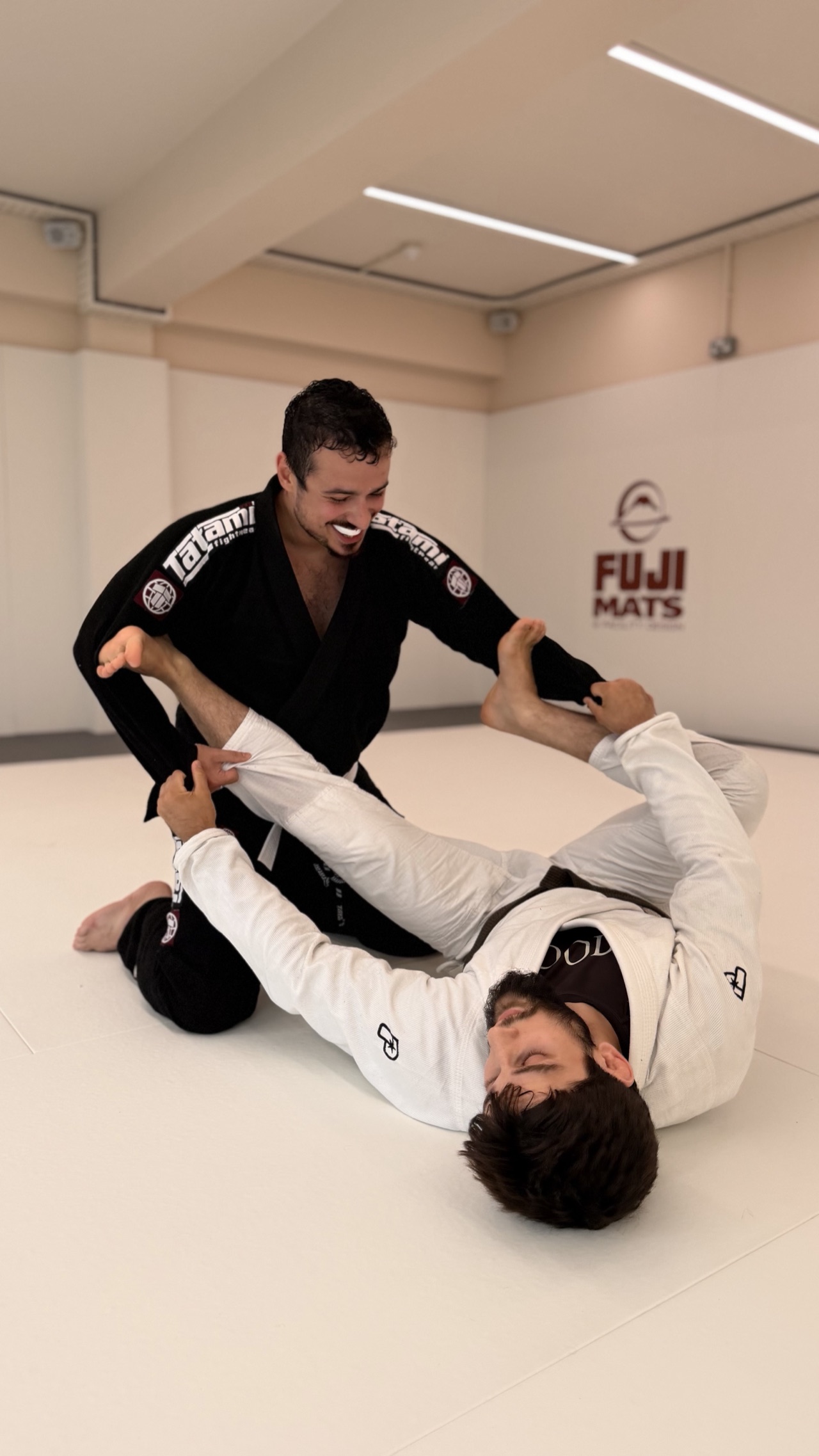 A coach demonstrating a grappling technique to beginner students at MOGA in Enfield