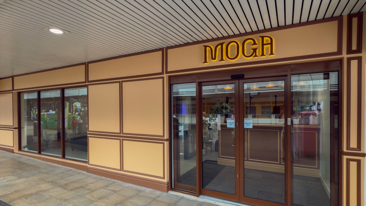 The entrance to MOGA on South Mall, with the illuminated MOGA sign above the doors