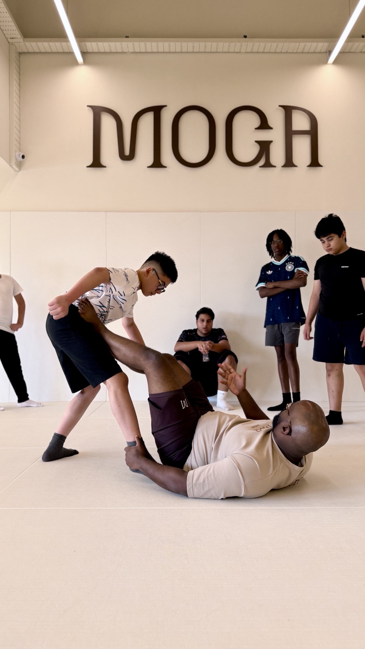 Teenagers sparring with a coach at MOGA